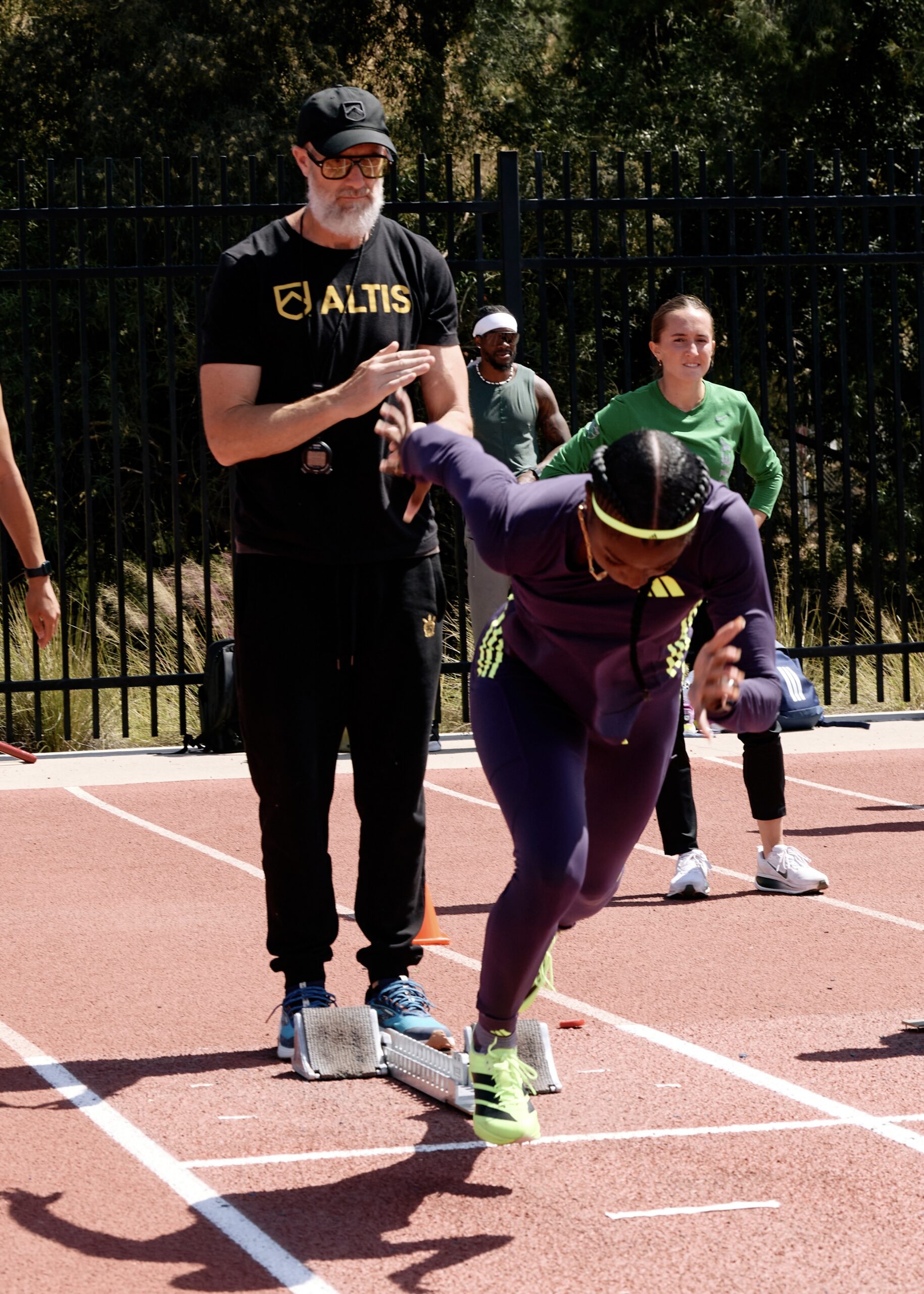 Stu McMillan coaching a sprinter.